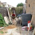Building site in an alley - just a mixer and some bollards